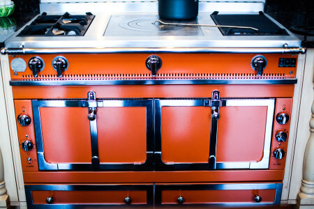 This savvy kitchen design from Conceptual Kitchens & Millwork makes a colorful statement via appliances.