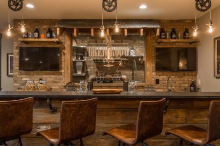 Ship lap Rustic and industrial materials used to create this unique lower level bar in the G&G Custom Home designed by Hilari Goris.